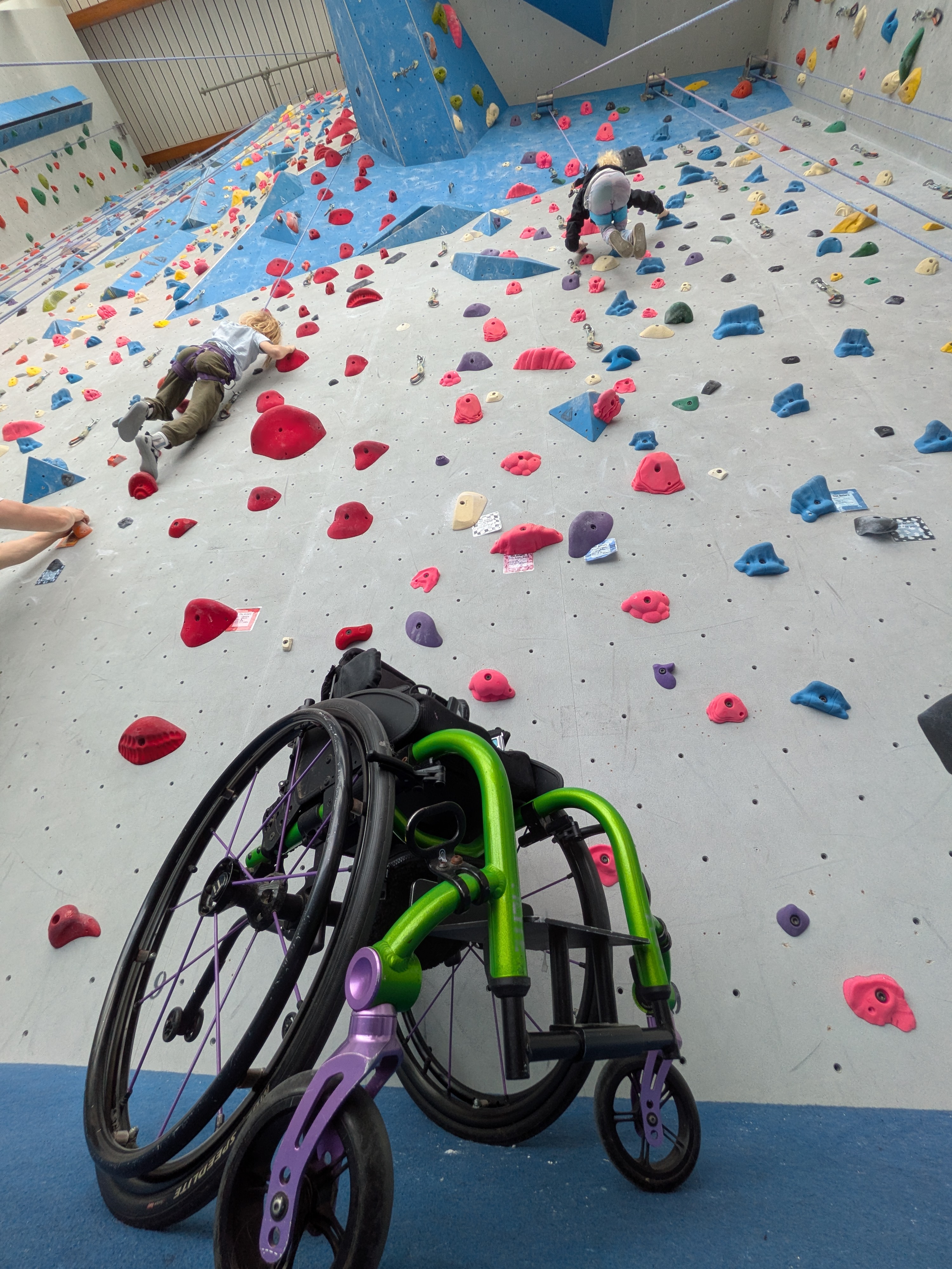 Wheelchair at base of climbing wall